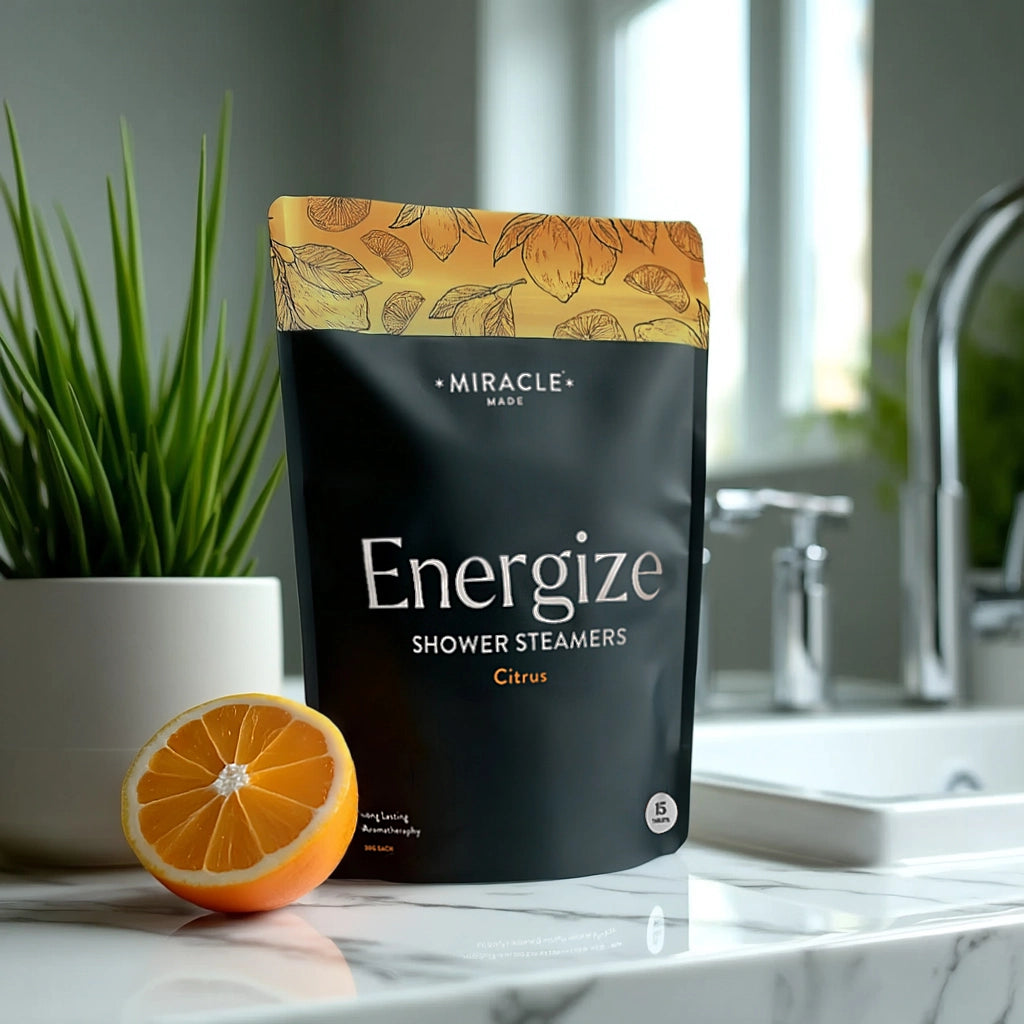 Bag of 'Energize' shower steamers with an orange and plant in a bathroom setting