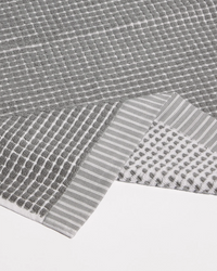 Gray textured fabric with geometric patterns on a white background