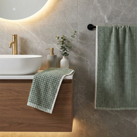 Bathroom setting with a sink, towel, and decorative elements.