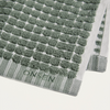 Green textured bath mat with 'Onsen' branding on a white background