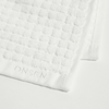 White textured towel with 'ONSEN' branding on a white background
