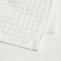 White textured towel with 'ONSEN' branding on a white background