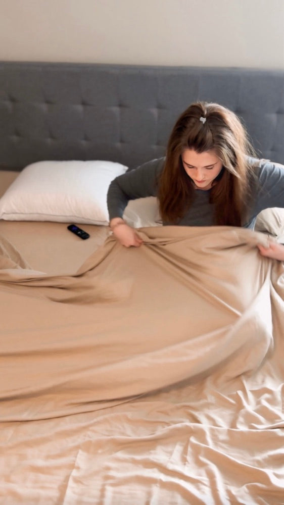 Customer putting fresh Miracle Made sheets on the bed