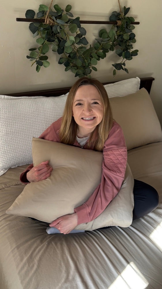 Customer hugging a Miracle Made pillow