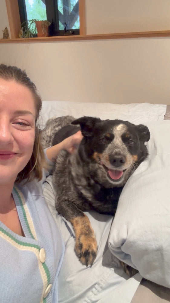 Customer and her dog on Miracle Made sheets
