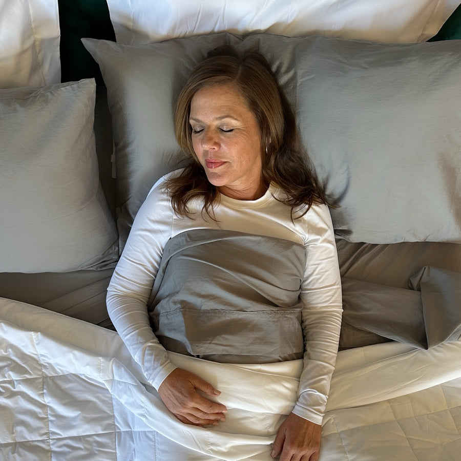Customer sleeping soundly in cool grey Miracle Made sheets