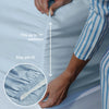 Person adjusting sky blue fitted sheet on a mattress with text indicating fit and stay put feature.