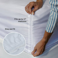 Person adjusting a fitted sheet on a mattress with text indicating fit and size.
