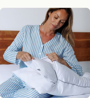 Woman adjusting a RemyCloud pillow insert
